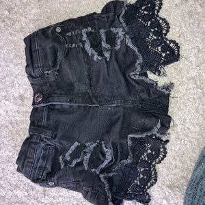 black shorts with lace on the bottom of pockets